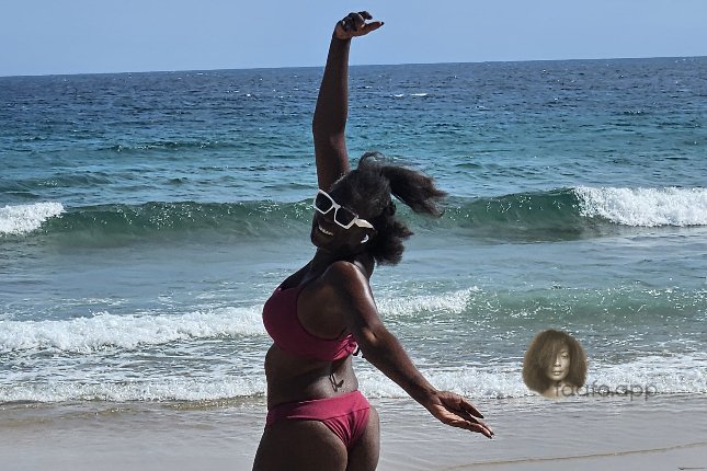 sisi in brasil on a bahia beach arm raised toward the atlantic ocean --- faafo.app